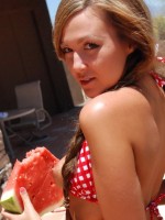 Country girl Craving Carmen makes a mess with her juicy watermelon in a tiny checkered string bikini and tiny jean shorts
