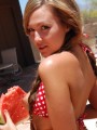 Country girl Craving Carmen makes a mess with her juicy watermelon in a tiny checkered string bikini and tiny jean shorts
